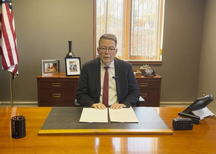 Tom Hood sitting at his desk showing that his office is always open.